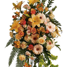 Tall floral standing spray with yellow lilies, roses, and gerbera daisies