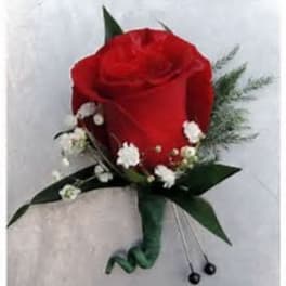Single red rose boutonniere with small white accent flowers and pins