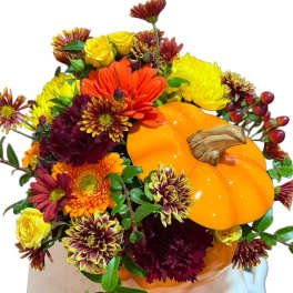 Fall bouquet with a pumpkin and mixed orange, yellow, and burgundy flowers