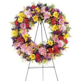 Colorful standing floral wreath on a metal easel