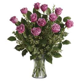 Pink roses arranged in a clear glass vase