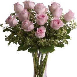Pink roses arranged in a clear glass vase