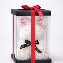 White rose teddy bear in a clear gift box with red ribbon
