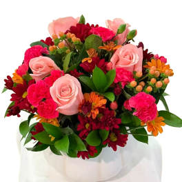 Bouquet of pink roses, carnations, and red-orange daisies