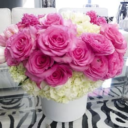 Pink and white flower arrangement in a white vase