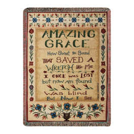 Decorative woven wall hanging with floral border and the words "Amazing Grace"