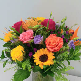 Colorful mixed bouquet in a textured glass vase