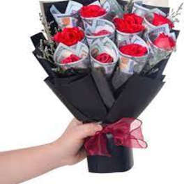 Bouquet of red roses wrapped in black paper with a red ribbon
