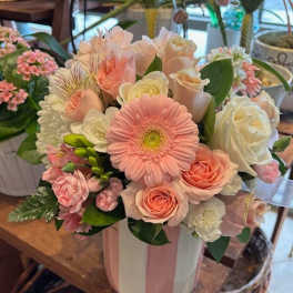 Pink and white mixed flower bouquet in a striped vase