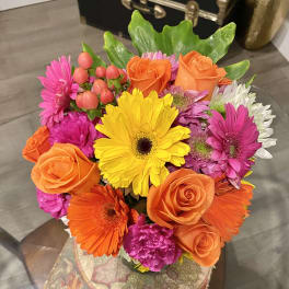 Bright mixed bouquet with orange roses, gerbera daisies, and pink flowers