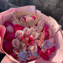 Pink and white rose bouquet with a jeweled crown and butterfly decorations