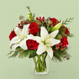 Red roses and white lilies in a clear glass vase