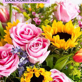 Pink roses and yellow sunflowers in a mixed bouquet