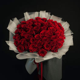 Large bouquet of red roses wrapped in white paper