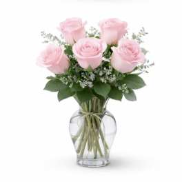 Pink roses arranged in a clear glass vase