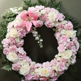 Pink and white floral wreath with a large pink lily
