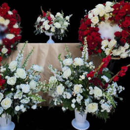 White and red rose funeral wreaths and arrangements on stands