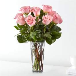 Pink roses arranged in a clear glass vase