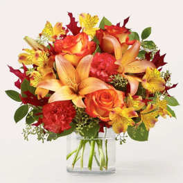Orange and yellow bouquet in a clear glass vase