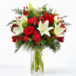 Bouquet of red roses and white lilies in a clear glass vase