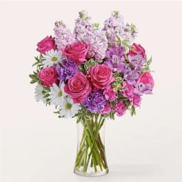 Pink and purple mixed bouquet in a clear glass vase