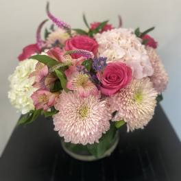 Pink roses and pale chrysanthemums in a glass vase