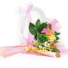 Pink and yellow flower bouquet in a clear gift bag with a "Happy Women's Day" sign