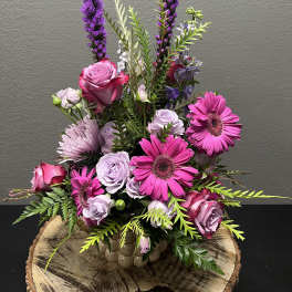 Pink and lavender floral arrangement in a ceramic vase