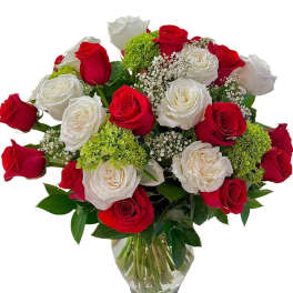 Bouquet of red and white roses in a clear glass vase