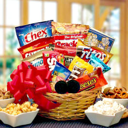 Basket of assorted snack bags with popcorn bowls and a red bow