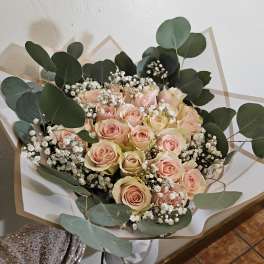 Bouquet of pale pink roses with white baby's breath and eucalyptus