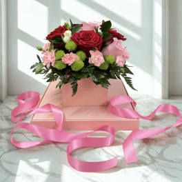 Pink and red rose bouquet in a pink gift box with ribbon