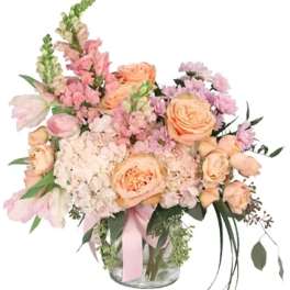 Pastel bouquet of roses and pink flowers in a glass vase