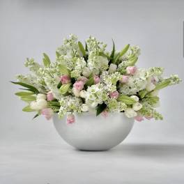 White and pink floral arrangement in a round silver bowl