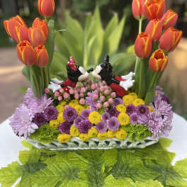 Basket arrangement with orange tulips and colorful mums featuring Mickey and Minnie figurines