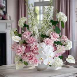 Pink and white floral arrangement in a white vase