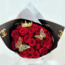 Bouquet of red roses with gold butterfly accents and a crown topper