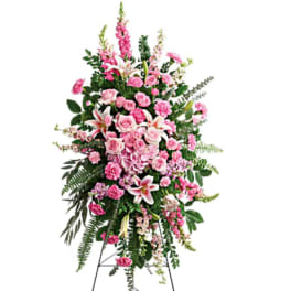 Tall pink floral standing spray on an easel
