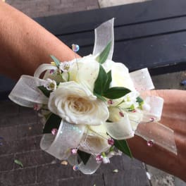 White rose wrist corsage with sheer ribbon and pink crystal accents