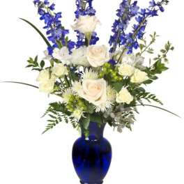 Blue and white floral arrangement in a cobalt vase