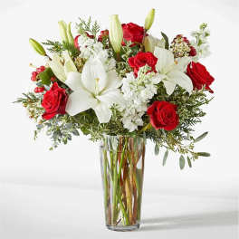 Red roses and white lilies in a clear glass vase