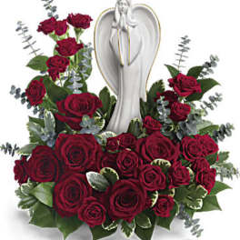 Red rose arrangement with a white angel statue centerpiece