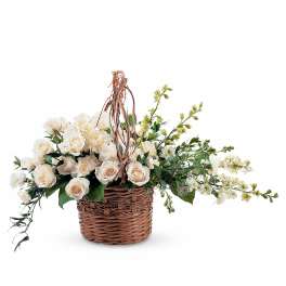 Cream roses and white flowers in a wicker basket