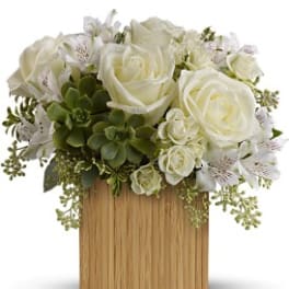 White roses and alstroemeria arranged in a wooden box