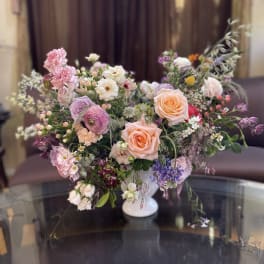 Mixed pastel bouquet in a white pedestal vase