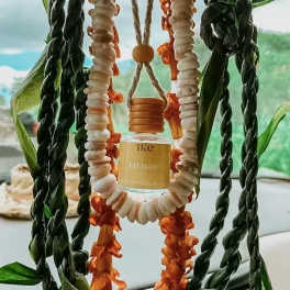 Hanging shell and flower garland with a small bottle in the center