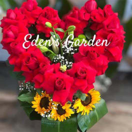 Heart-shaped bouquet of red roses with sunflowers at the base