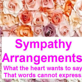 Pink and peach roses behind a sympathy arrangements sign