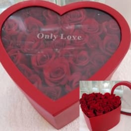 Heart-shaped red box filled with red roses and labeled Only Love