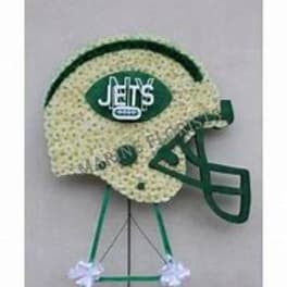 Football-shaped floral tribute on a stand with a Jets logo